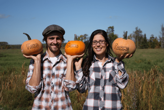 farmers holding pumpkins